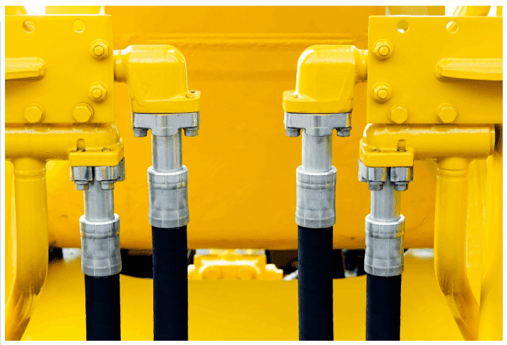 Four yellow and black pipes sitting next to each other.