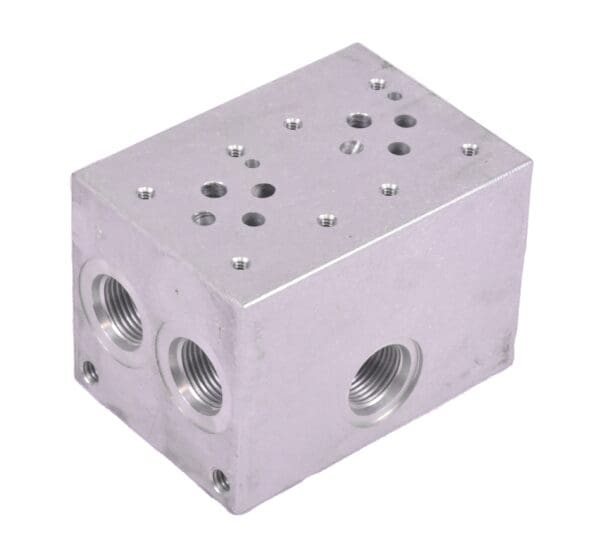 A silver block with two holes and three different locations.