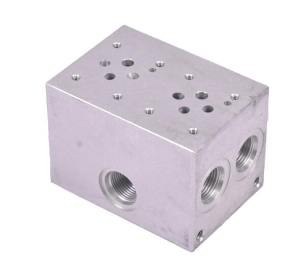 A silver block with holes and three different valves.