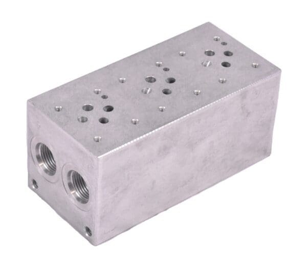 A silver block with holes on top of it.