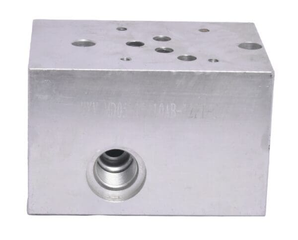 A silver block with holes for the air valve.